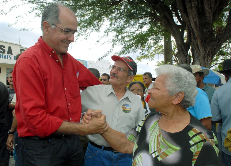 older people having fun and dancing while others watch