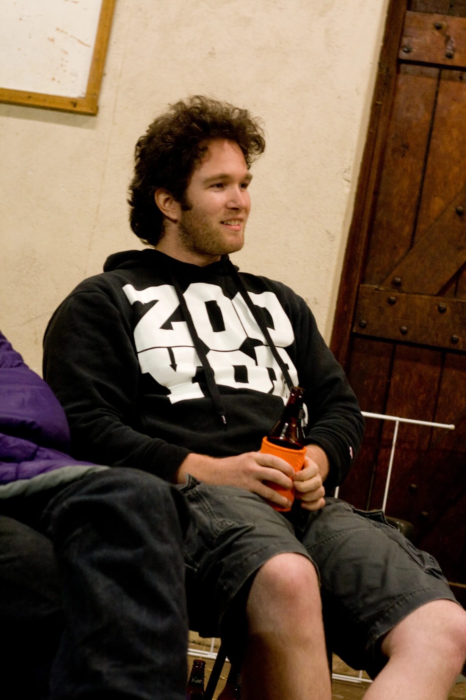 there is a young man in black sitting on a bench