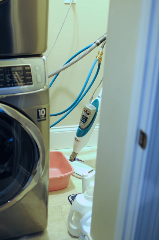 some blue and white cables next to a silver washing machine