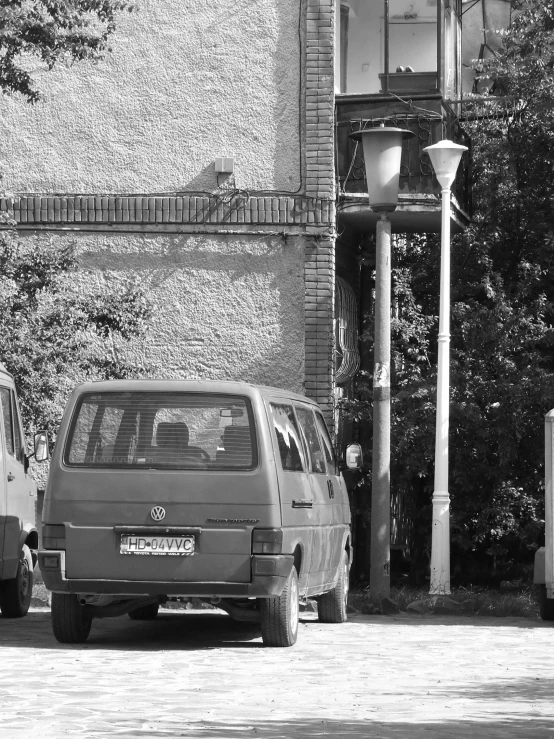 a black and white po of a minivan on the side of a road