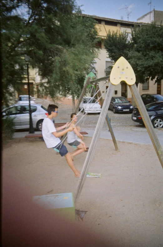 a father and daughter are playing on the playground