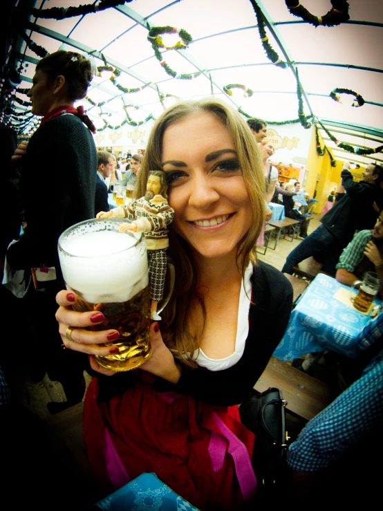 a woman holding a large pint and smiling