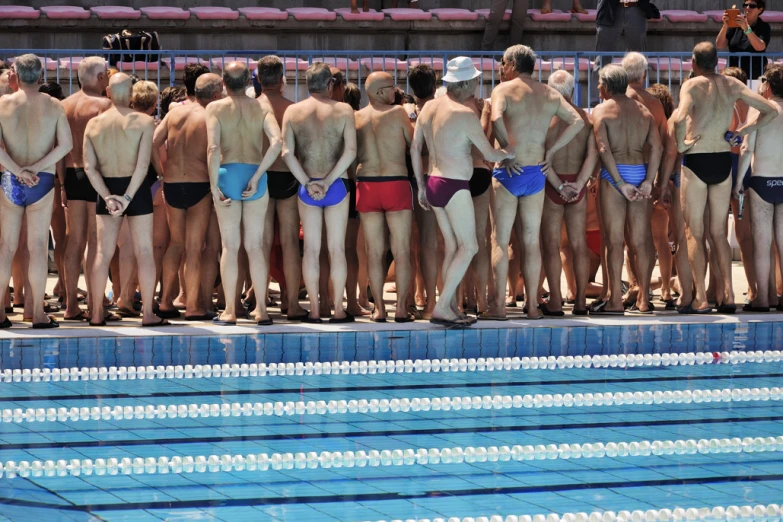 men and women standing on a diving pool