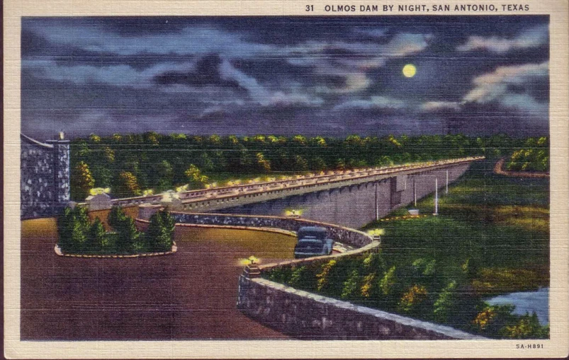 an old color postcard shows a scenic roadway and city in the background