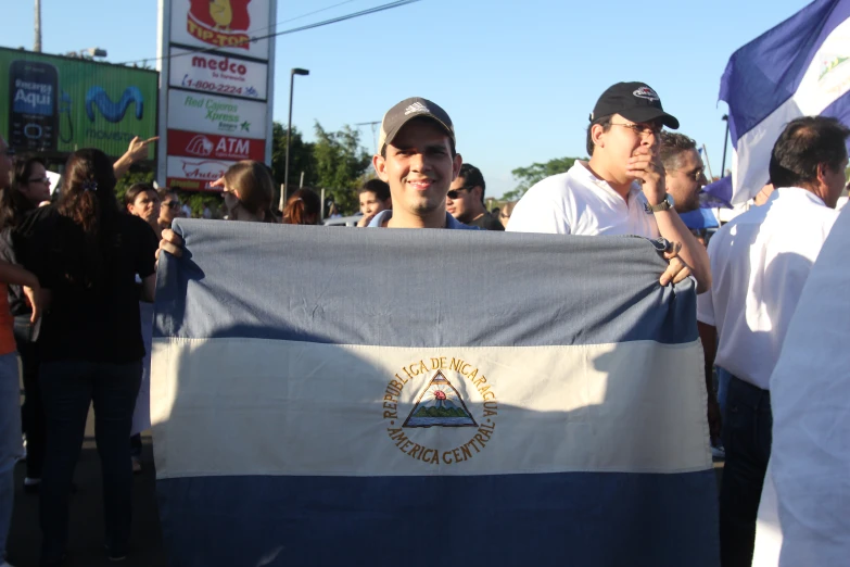 there are many people holding a flag in the street