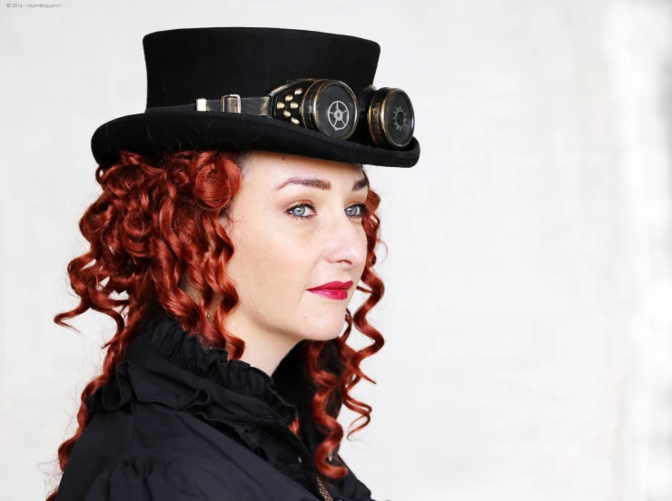 a woman is looking ahead while wearing a top hat