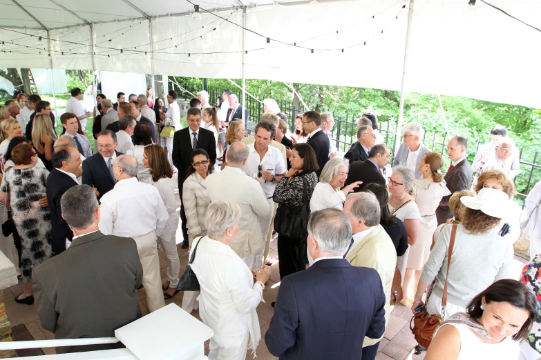 a large group of people in suits and ties at an event