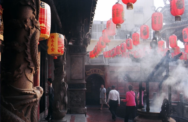 a city filled with tall buildings covered in red lanterns