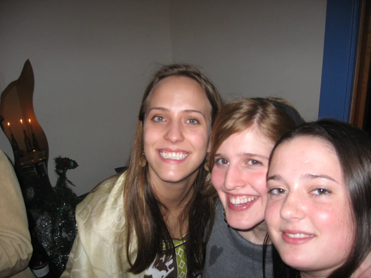 three beautiful young women posing for a picture together