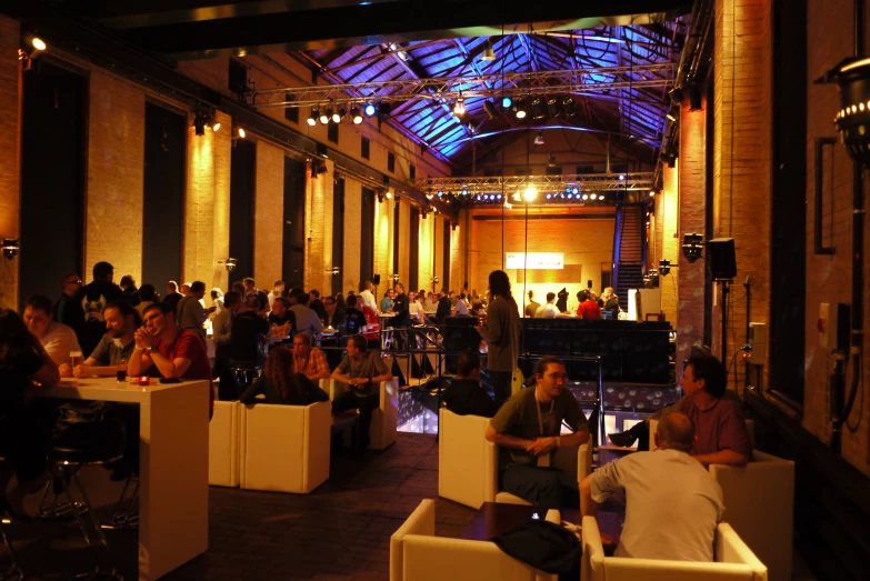 a large group of people eating food in a building