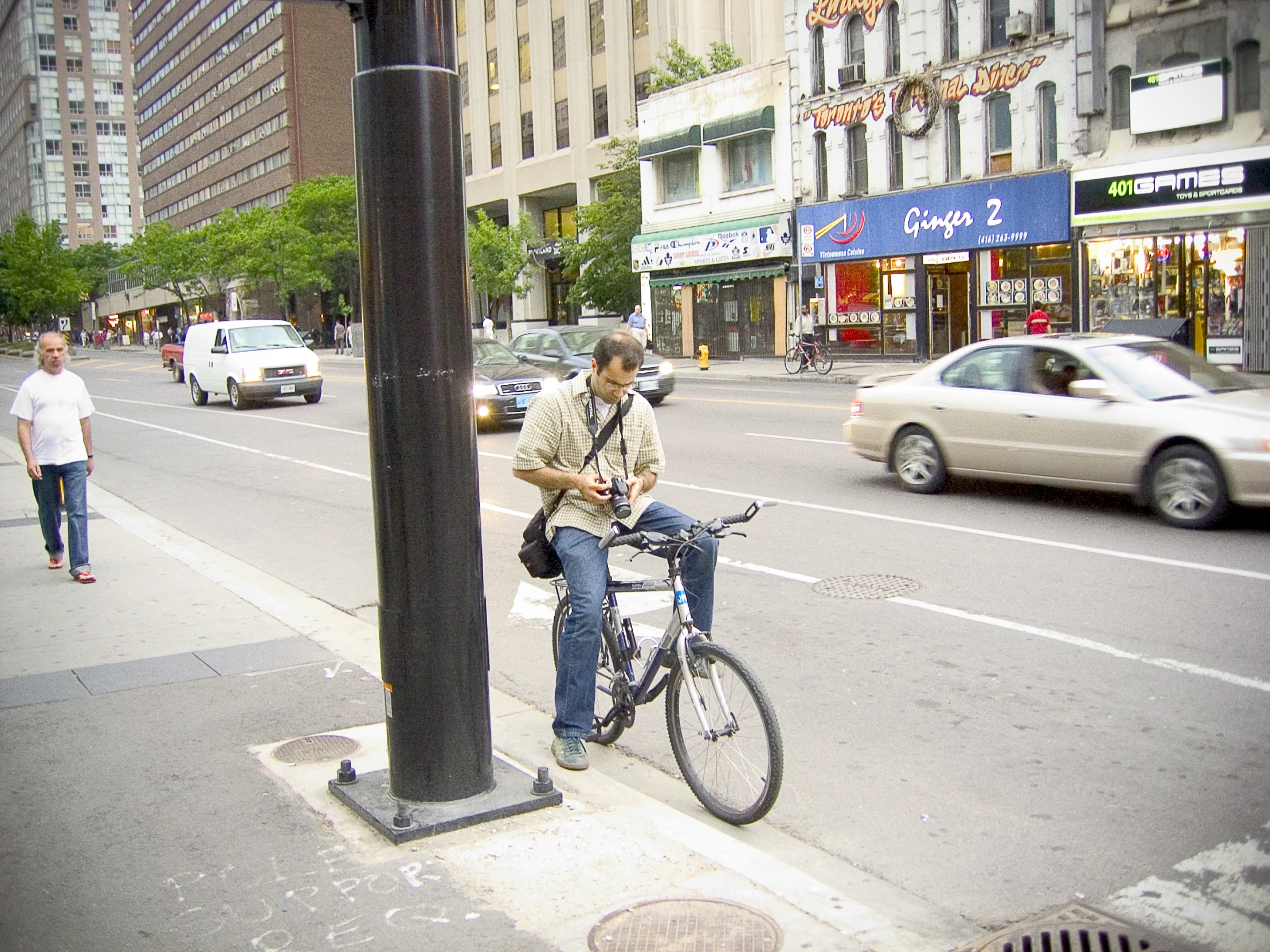 a man that is sitting on a bicycle near a pole