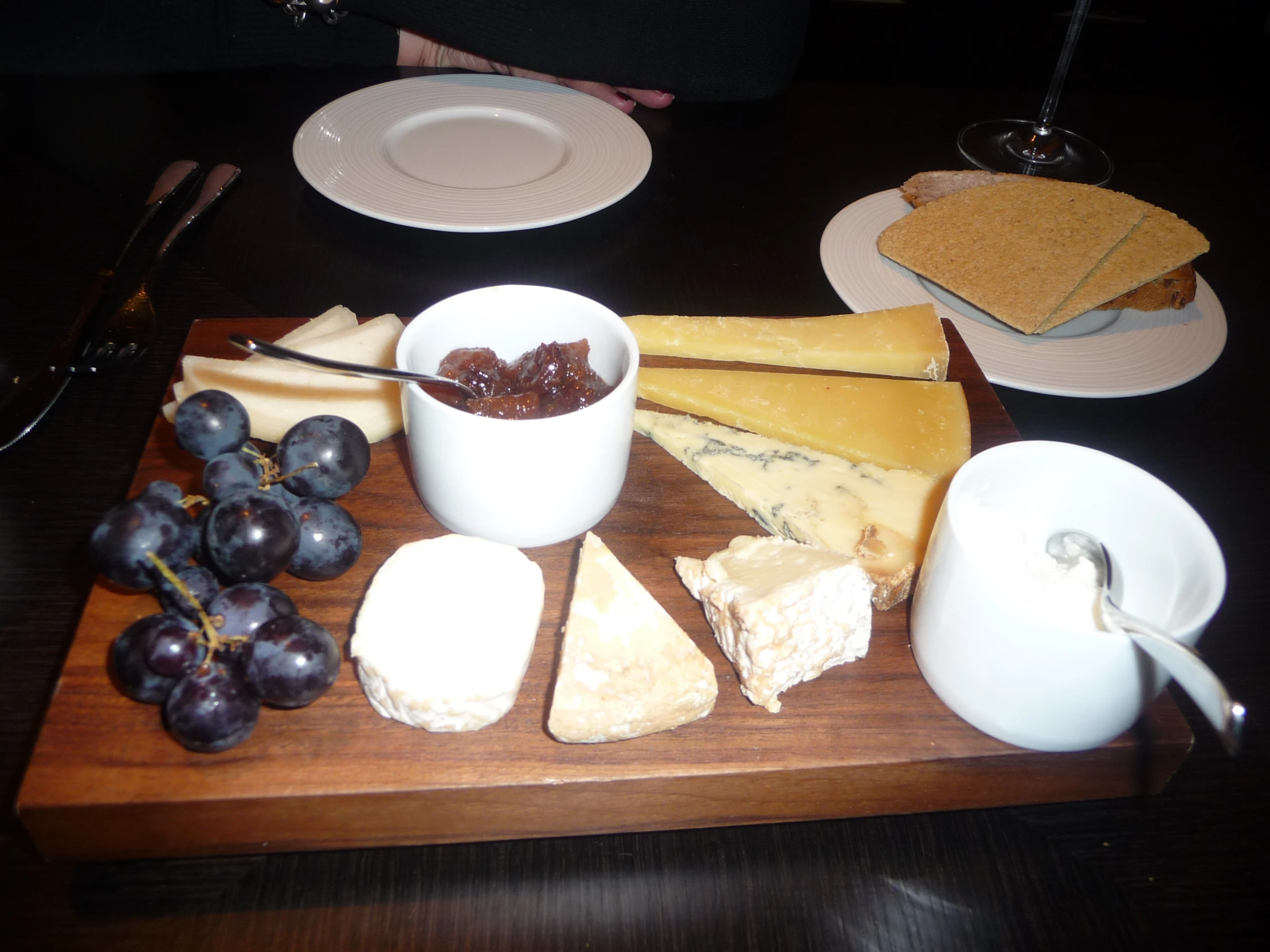 cheese, gs and bread are placed on a  board