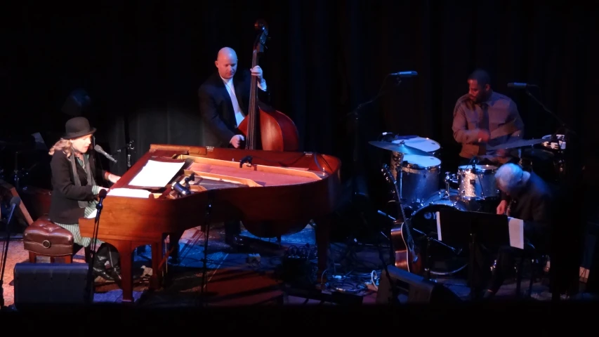 a band playing musical instruments while wearing suits