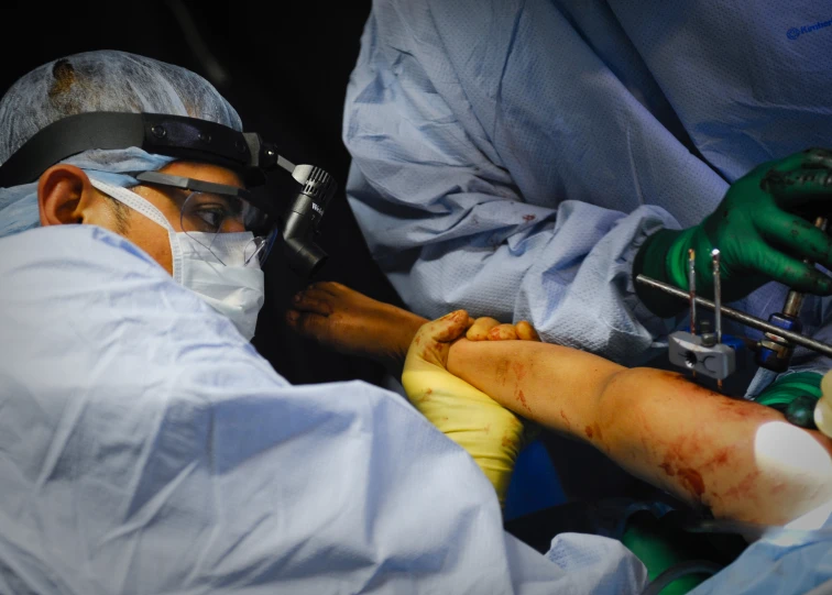 a surgeon putting a breathing tube into someone's arm