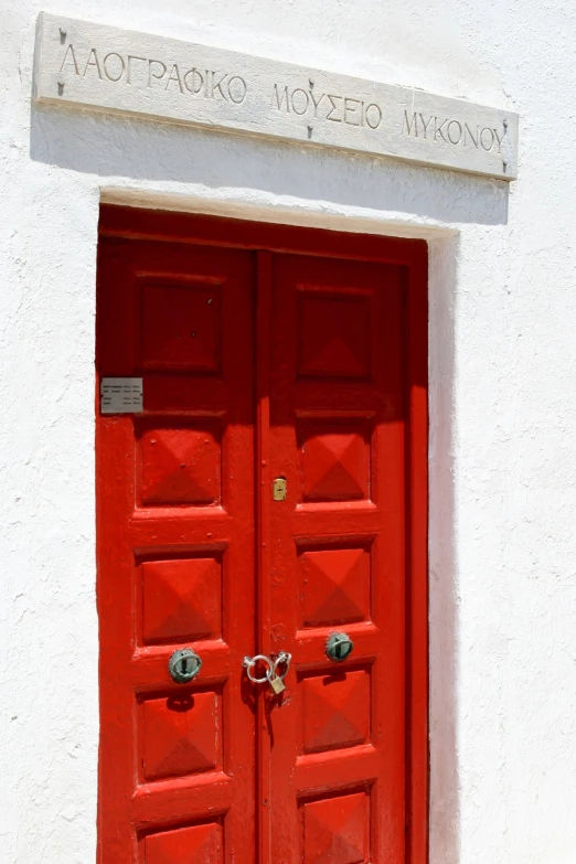 a red door with no top and two small ss keys on each side