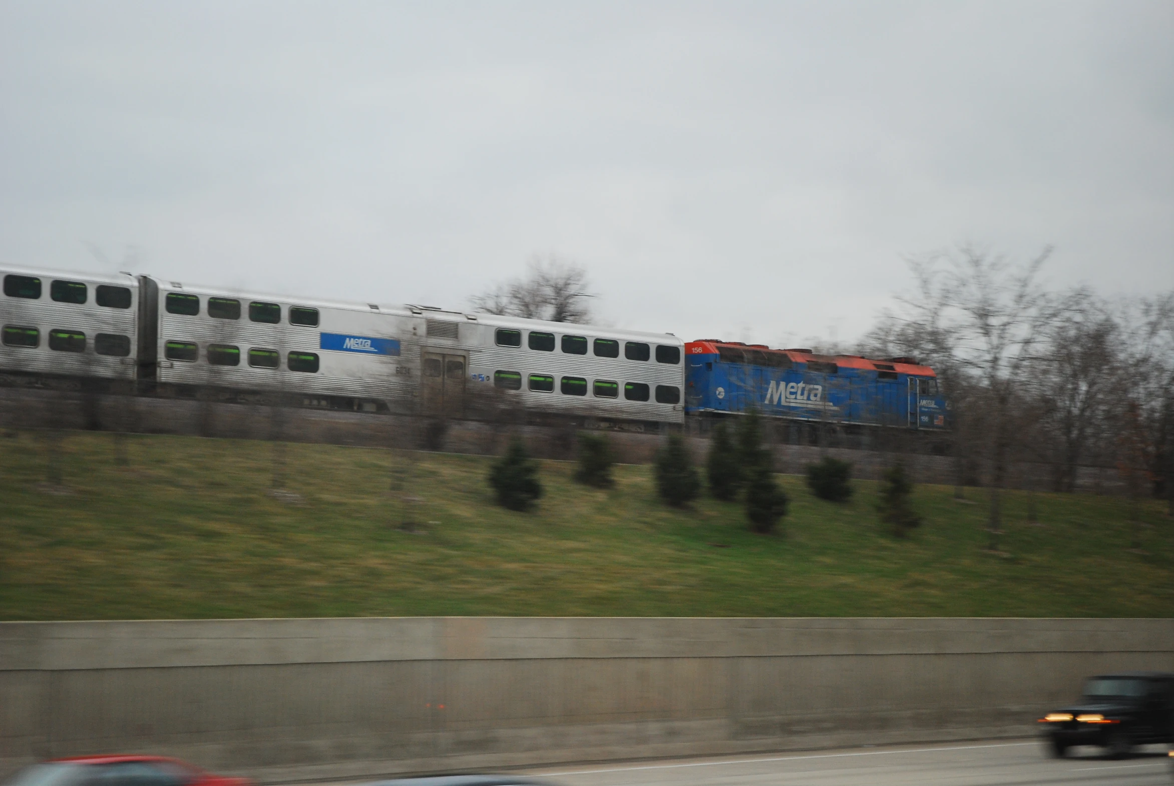 a train travels along the rails next to a city street