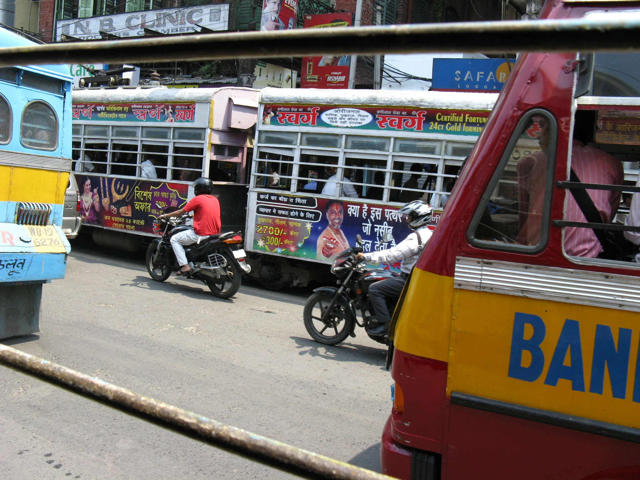 the buses and motorcycles pass on the street