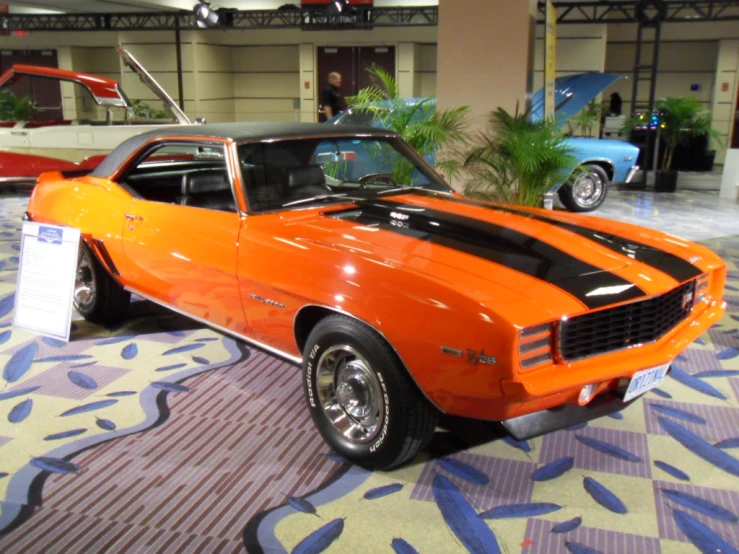 a car on display at the museum in orange