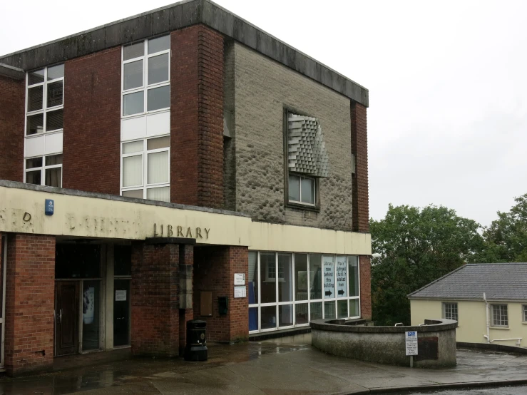 a large building sitting next to a sidewalk