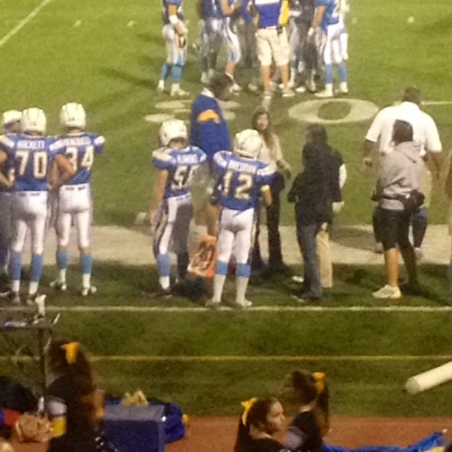 a group of young football players shaking hands