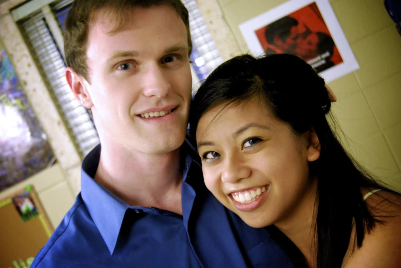 a man and woman are smiling for the camera