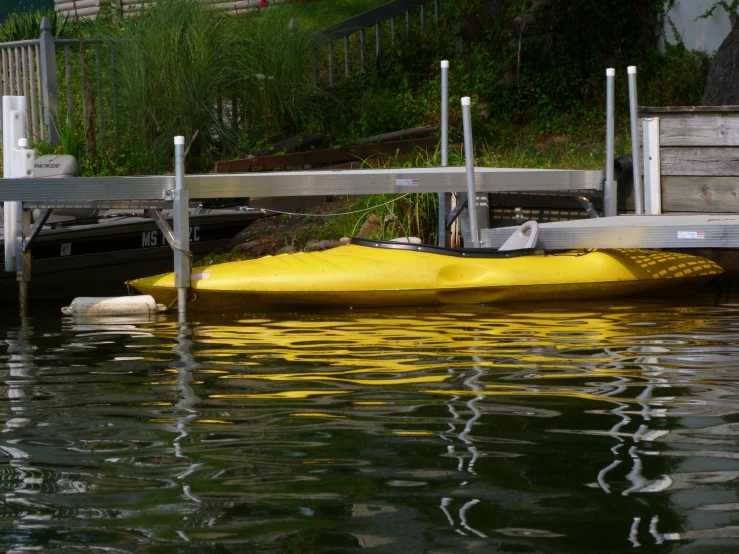 two yellow boats sitting at the end of a dock