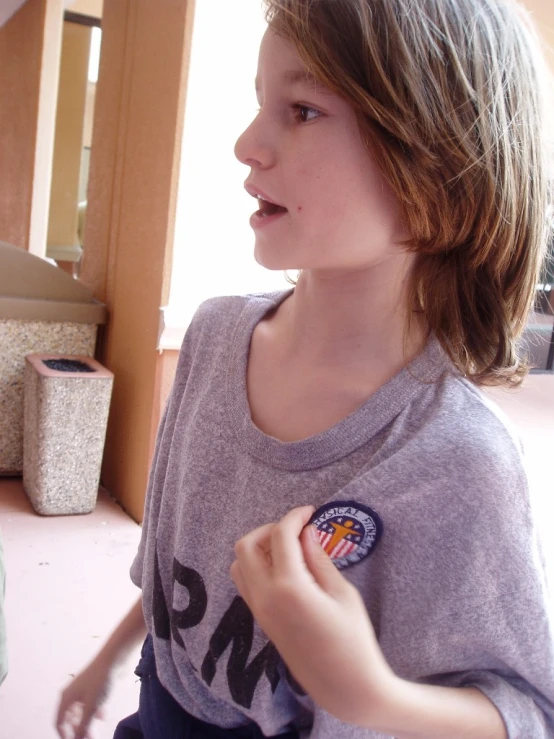  in grey shirt holding a doughnut near a door