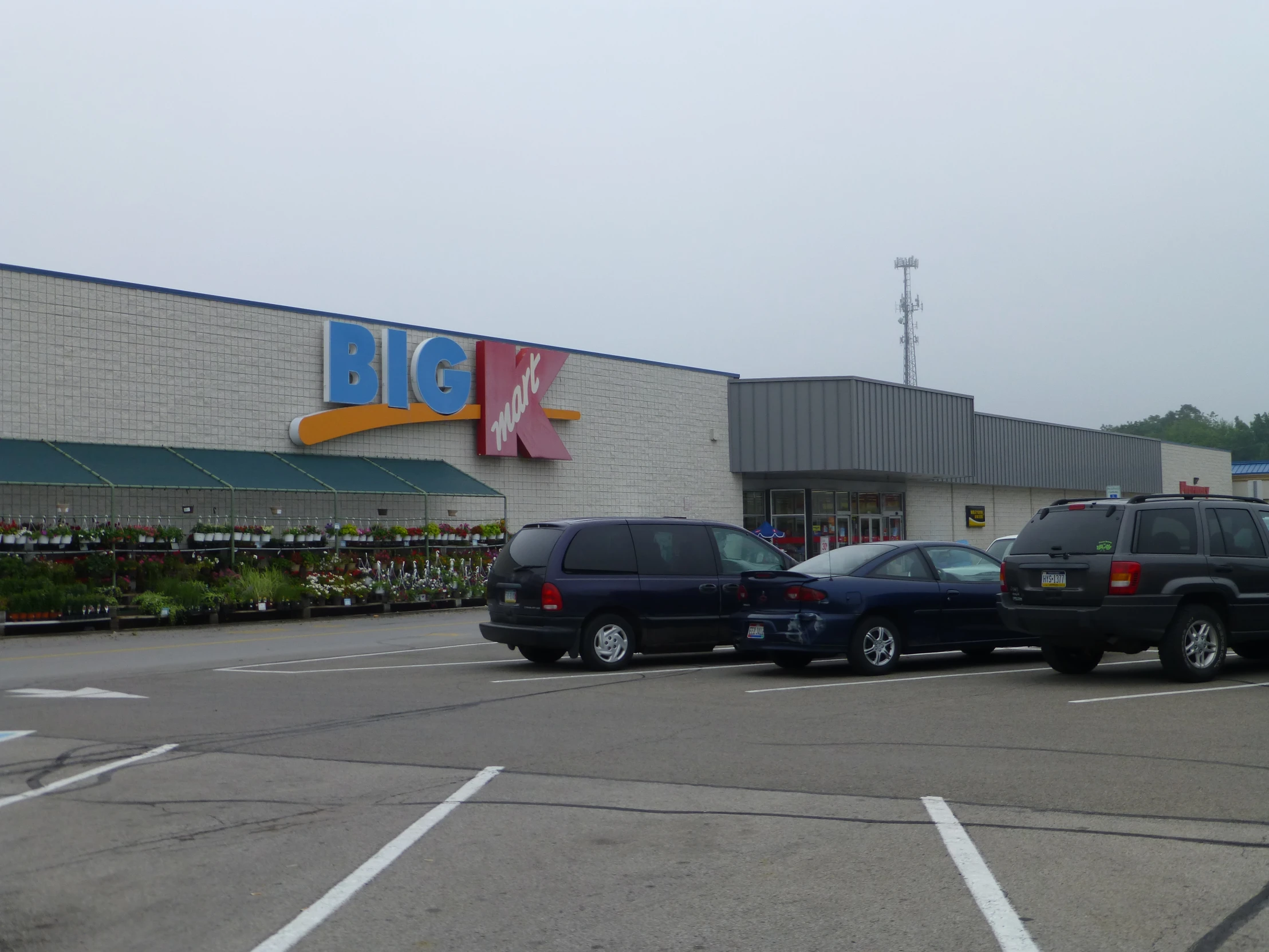 black suv parked in front of a big c store