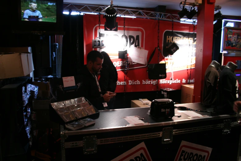 some people standing behind a booth for a radio station