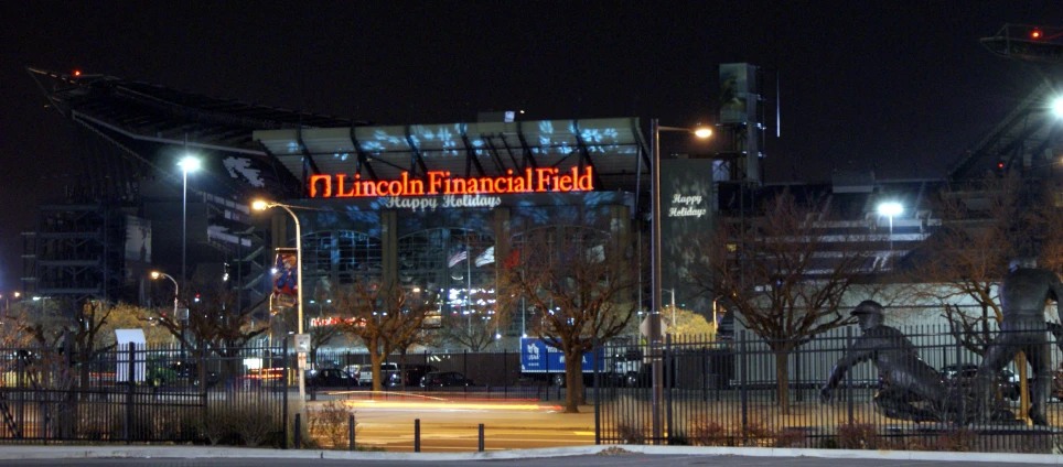 a large building with a lit sign at night