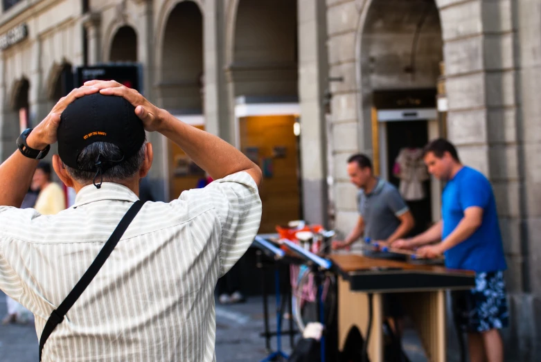 a man looks through a hole with his hat in the middle