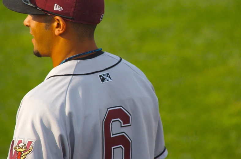 a baseball player in uniform standing on a field