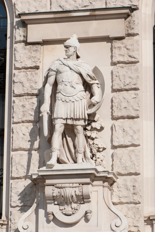 the large statue is near an arch