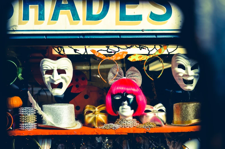 several costumes and masks on a shelf for sale
