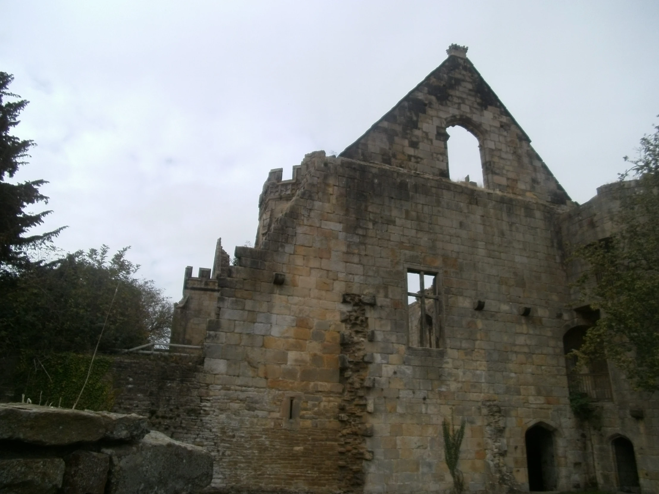 an old stone building is near some trees