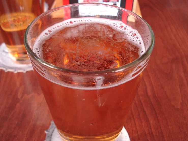 a drink glass full with some liquid on the bottom