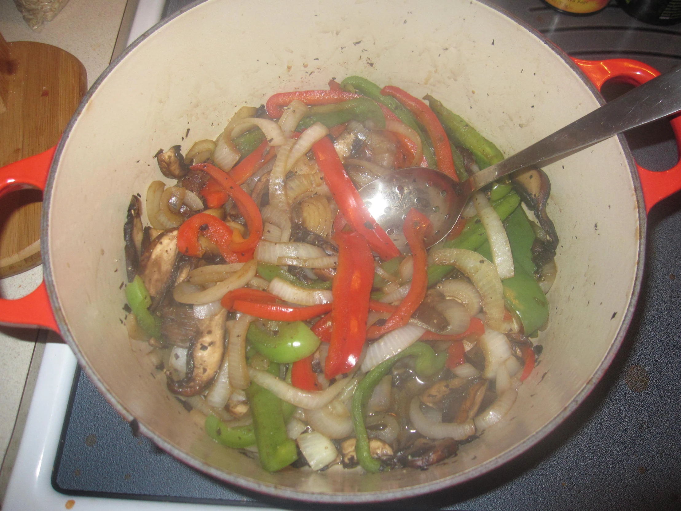 a wok filled with food sitting on top of a stove