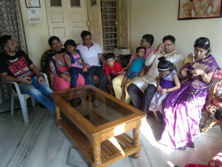 a group of people sitting in front of a table