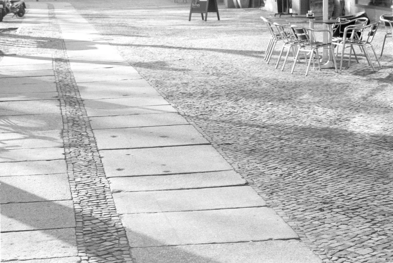 the view of a bench in a shaded public area