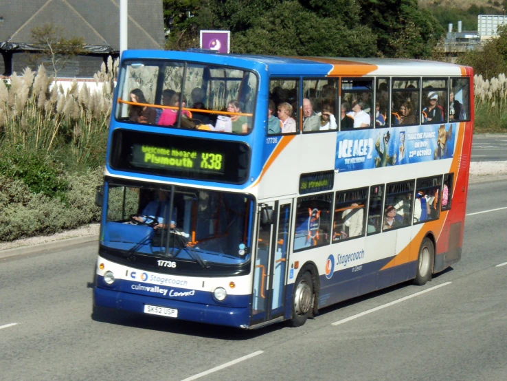 a double decker bus is traveling down the street