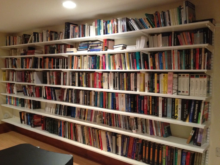 bookshelves are full of various books in an empty room