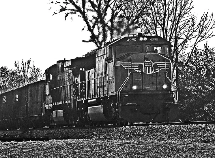 a train moving down tracks next to trees