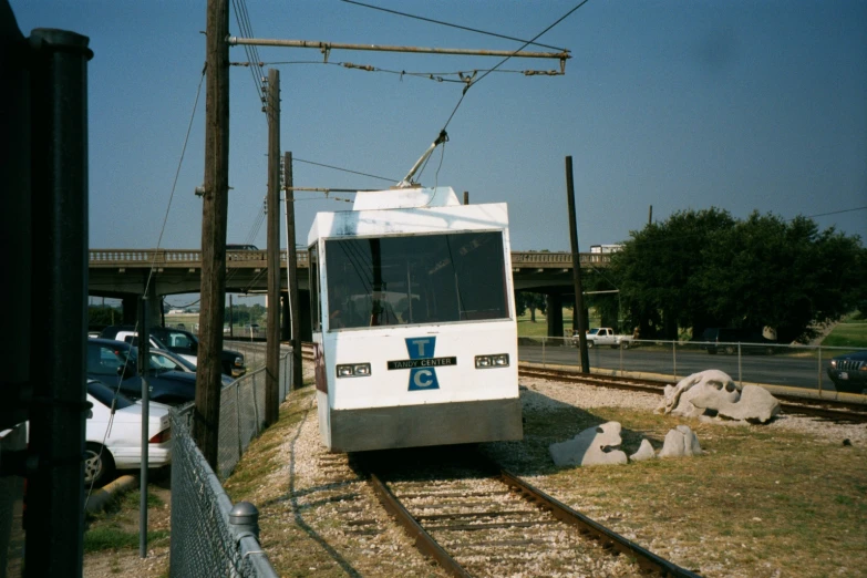 a train going down some tracks near a street