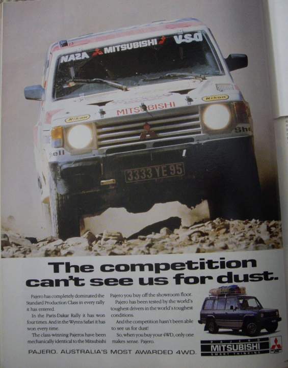 a magazine ad for a white van with two tires on it