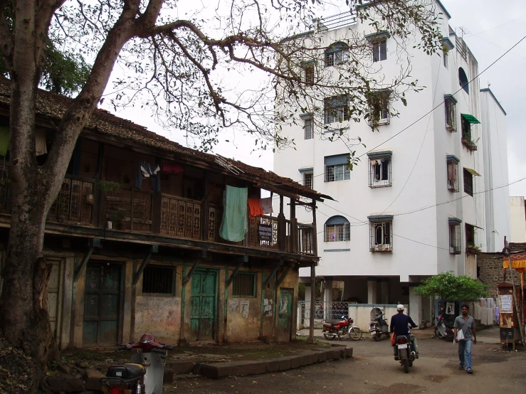 some people walk on a paved street near buildings