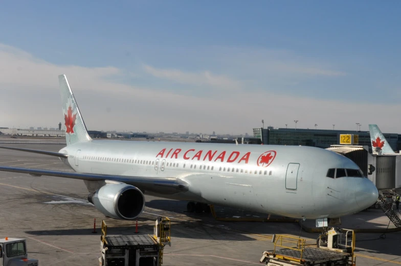 a large air canada airplane parked in an airport