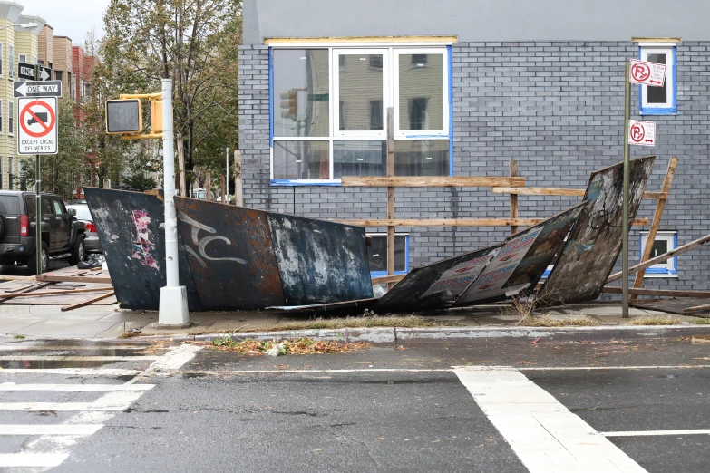 the boat is laying on its side in the street