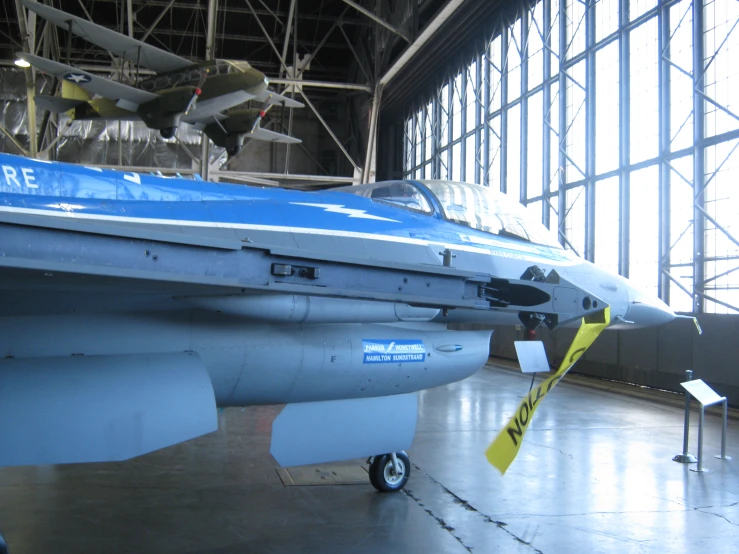 a display with a blue plane and people looking at it