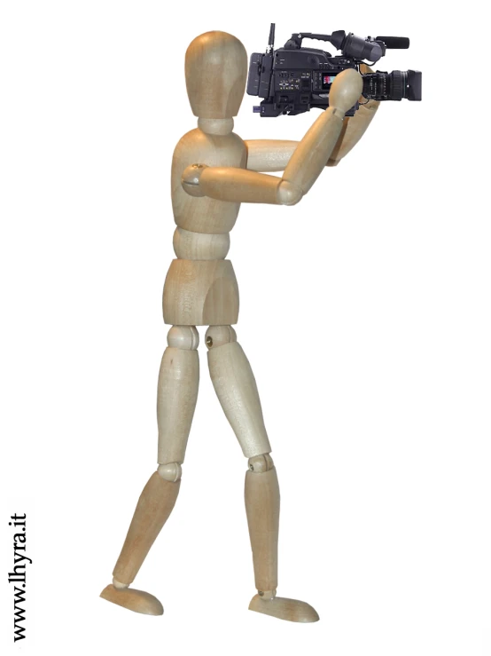 a wooden figurine holding a camera with the body of a person in it