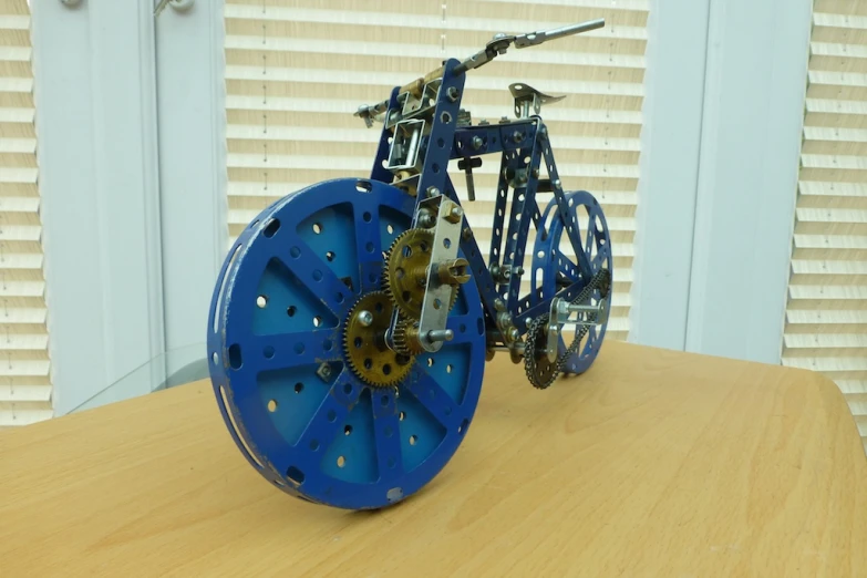 a small blue object with gears attached